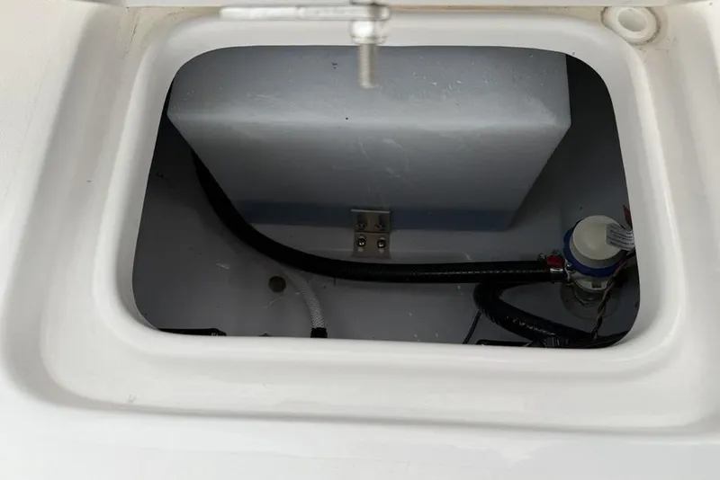 Slide: The Image of Storage compartment of 2026 Tidewater 232 CC Adventure boat, featuring wiring and components. - 27
