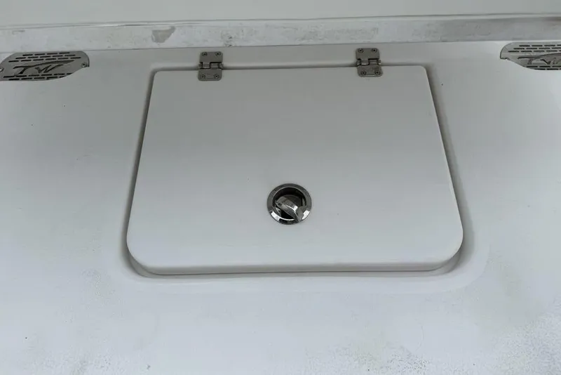Slide: The Image of Hatch cover on 2026 Tidewater 232 CC Adventure boat, featuring stainless steel latch. - 28