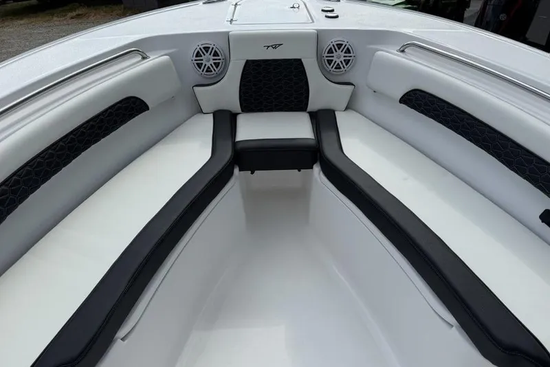 Slide: The Image of 2026 Tidewater 232 CC Adventure boat interior with cushioned seating and speakers. - 29