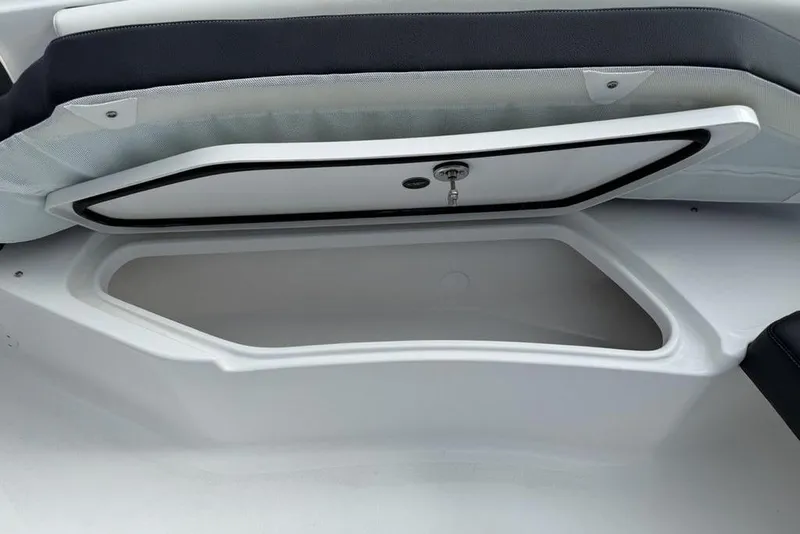 Slide: The Image of Storage compartment on 2026 Tidewater 232 CC Adventure boat, open with visible interior. - 30