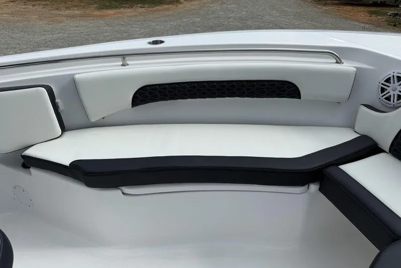 Slide: The Image of 2026 Tidewater 232 CC Adventure boat interior with cushioned seating and speaker. - 4