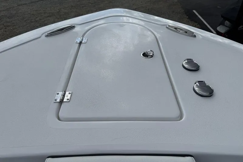 Slide: The Image of 2026 Tidewater 232 CC Adventure boat deck with storage hatch and fittings. - 8