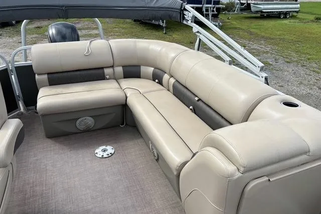Slide: The Image of 2021 Sun Tracker Party Barge 20 DLX with beige seating, outdoor setting. - 12