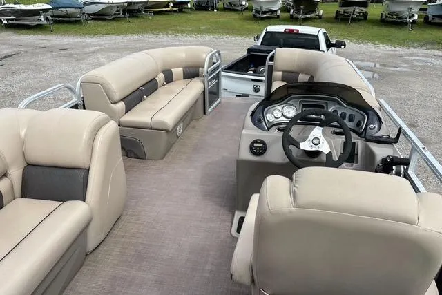 Slide: The Image of 2021 Sun Tracker Party Barge 20 DLX pontoon boat interior with plush seating and steering console. - 15