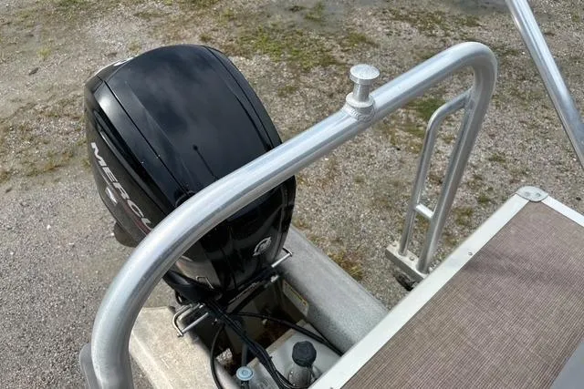 Slide: The Image of 2021 Sun Tracker Party Barge 20 DLX with Mercury outboard motor, docked on gravel. - 16