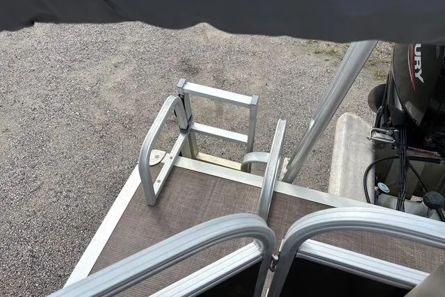 Slide: The Image of 2021 Sun Tracker Party Barge 20 DLX boat ladder and deck view. - 17