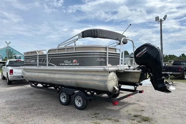 Slide: The Image of 2021 Sun Tracker Party Barge 20 DLX pontoon boat on trailer, parked outdoors. - 4