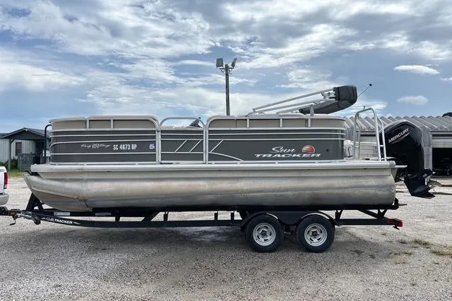 Slide: The Image of 2021 Sun Tracker Party Barge 20 DLX pontoon boat on trailer, parked outdoors. - 5