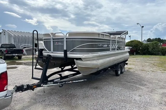 Slide: The Image of 2021 Sun Tracker Party Barge 20 DLX pontoon boat on trailer, parked outdoors. - 6