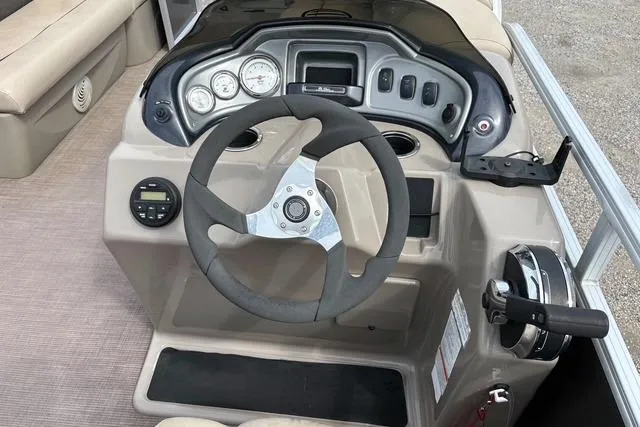Slide: The Image of 2021 Sun Tracker Party Barge 20 DLX steering console with gauges and controls. - 8