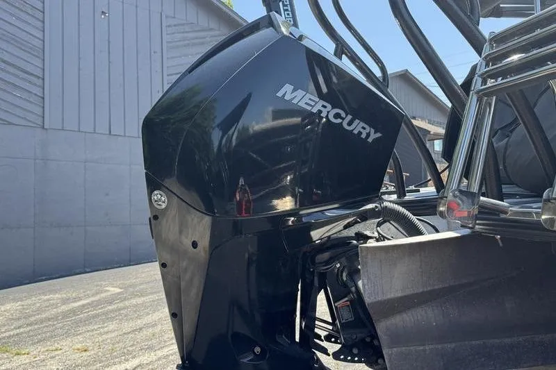 Slide: The Image of 2020 Crest Caribbean LX 250 SLC with Mercury outboard motor, parked outdoors. - 4