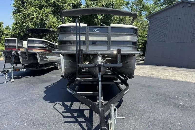 Slide: The Image of 2020 Crest Caribbean LX 250 SLC pontoon boat on trailer, parked outdoors. - 5