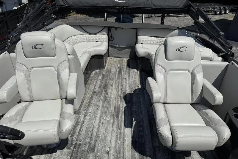 Slide: The Image of 2020 Crest Caribbean LX 250 SLC boat interior with plush seating and wood-style flooring. - 8