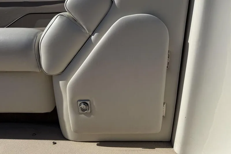Slide: The Image of Interior detail of a 2002 Godfrey AP220RS boat, featuring cushioned seating and storage compartment. - 12