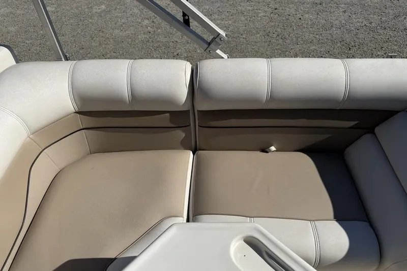 Slide: The Image of Beige seating on a 2002 Godfrey AP220RS boat, featuring comfortable cushions. - 16