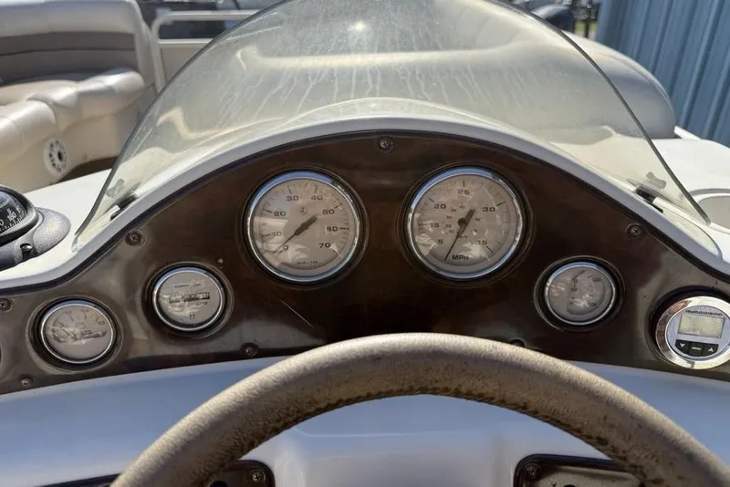 Slide: The Image of Dashboard of a 2002 Godfrey AP220RS boat with gauges and steering wheel. - 18