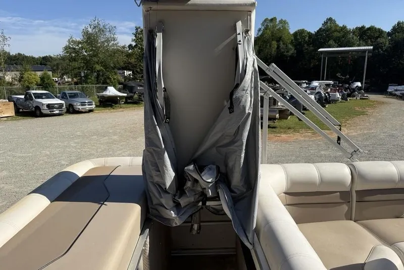Slide: The Image of 2002 Godfrey AP220RS boat interior with storage compartment and seating. - 21