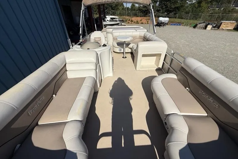 Slide: The Image of Interior of a 2002 Godfrey AP220RS pontoon boat with beige seating and table. - 26