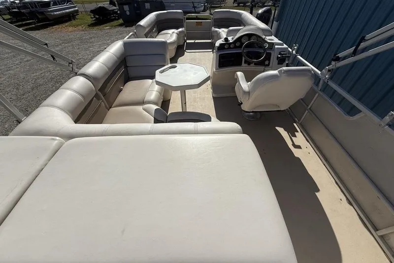 Slide: The Image of 2002 Godfrey AP220RS pontoon boat interior with white seating and steering console. - 27