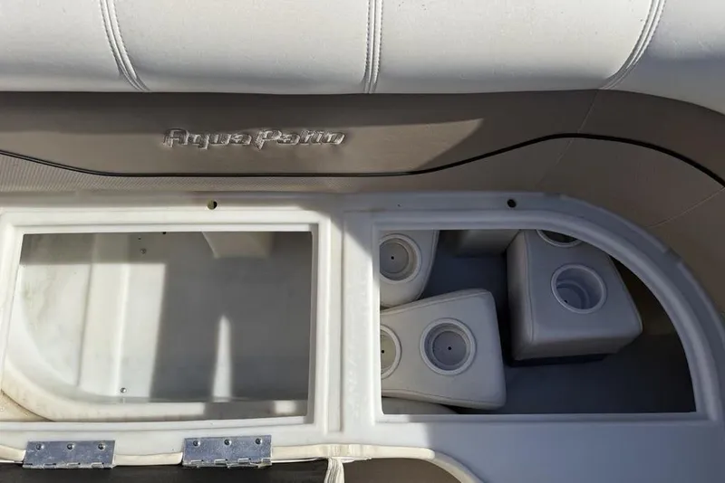 Slide: The Image of Interior of a 2002 Godfrey Aqua Patio AP220RS boat with cup holders and storage. - 3