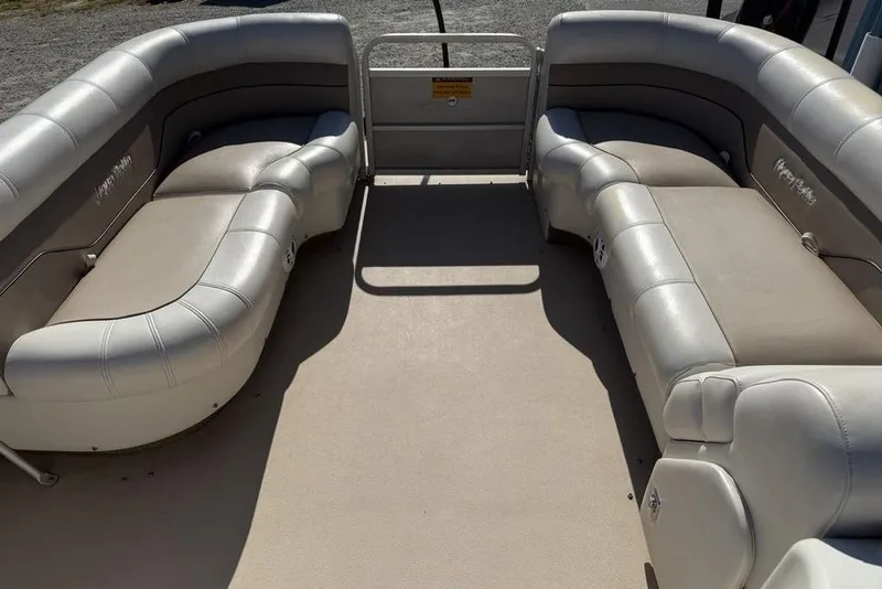 Slide: The Image of Interior of a 2002 Godfrey AP220RS pontoon boat with beige seating. - 4