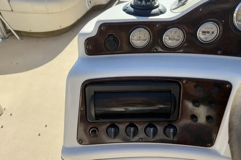 Slide: The Image of Control panel of a 2002 Godfrey AP220RS boat with gauges and switches. - 8