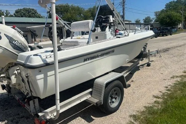 Slide: The Image of 2000 Hydra-Sports 175 boat on trailer, featuring Johnson outboard motor, parked outdoors. - 2