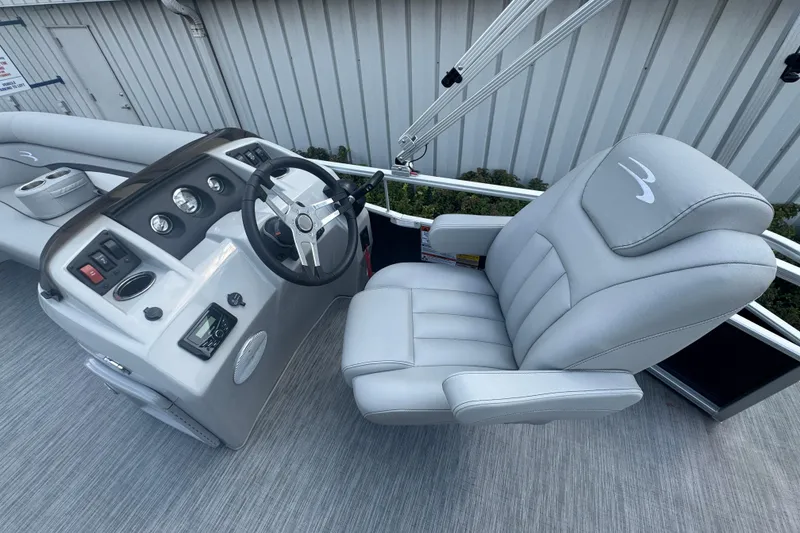 Slide: The Image of 2023 Bennington 20 SL boat interior with steering wheel and plush captain's chair. - 10