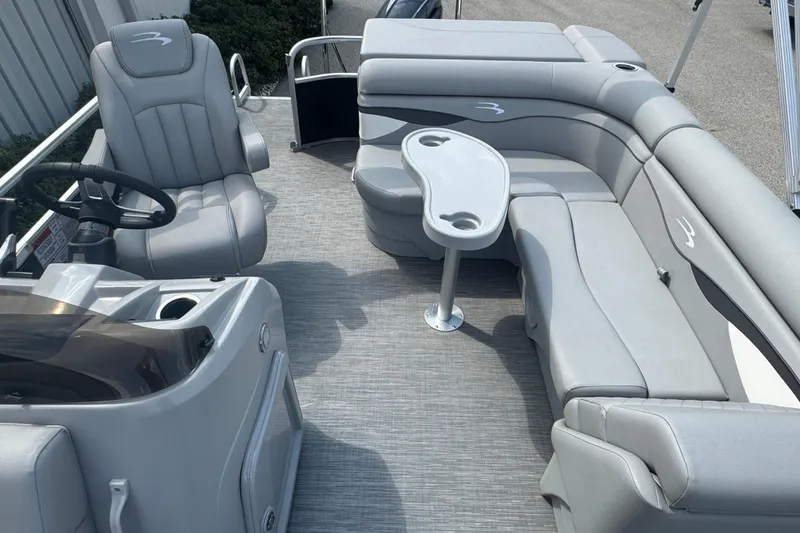 Slide: The Image of 2023 Bennington 20 SL pontoon boat interior with gray seating and steering console. - 11
