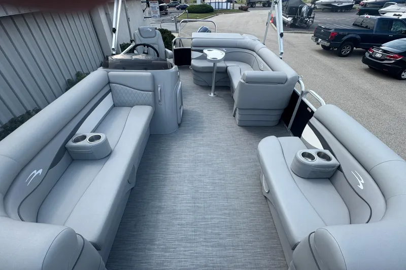 Slide: The Image of 2023 Bennington 20 SL pontoon boat interior with gray seating and cup holders. - 14