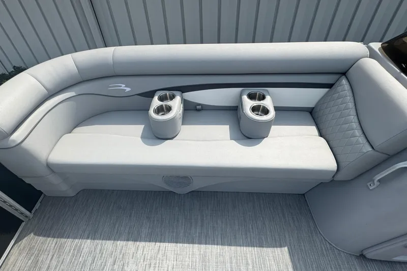 Slide: The Image of 2023 Bennington 20 SL boat interior with gray seating and dual cup holders. - 17