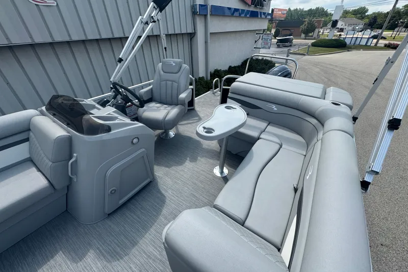 Slide: The Image of 2023 Bennington 20 SL pontoon boat interior with gray seating and helm. - 18