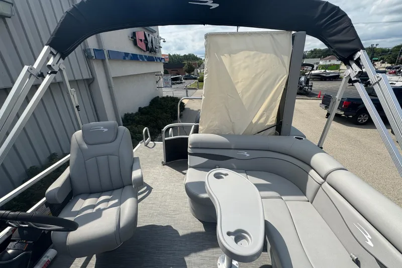 Slide: The Image of 2023 Bennington 20 SL pontoon boat interior with seating and canopy. - 19