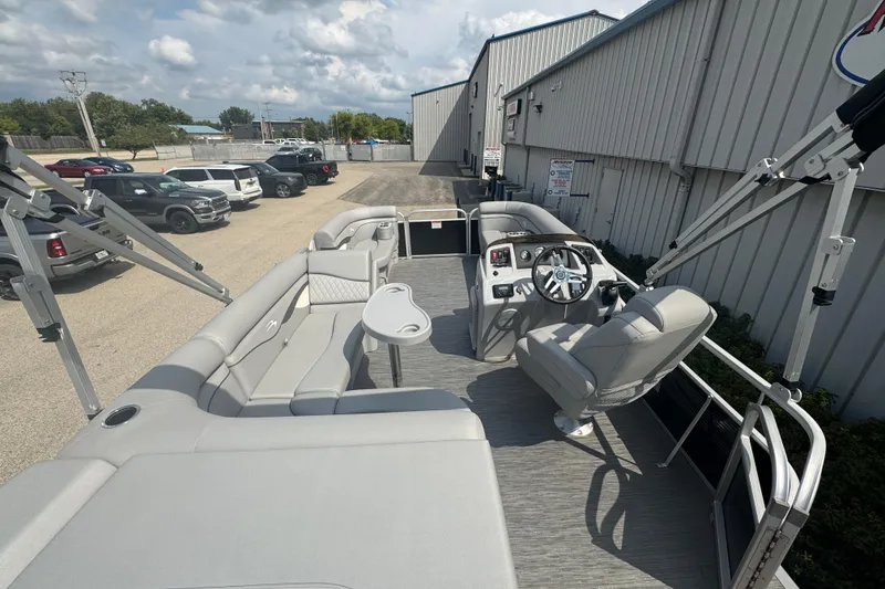 Slide: The Image of 2023 Bennington 20 SL pontoon boat with spacious seating and modern controls. - 20