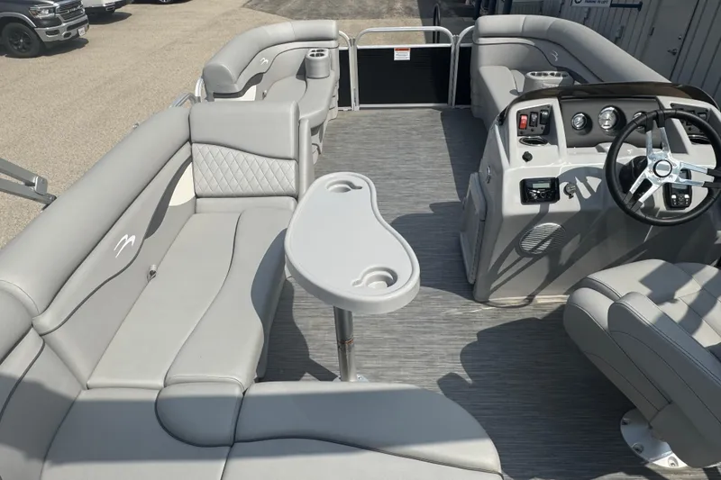 Slide: The Image of 2023 Bennington 20 SL pontoon boat interior with gray seating and steering console. - 21