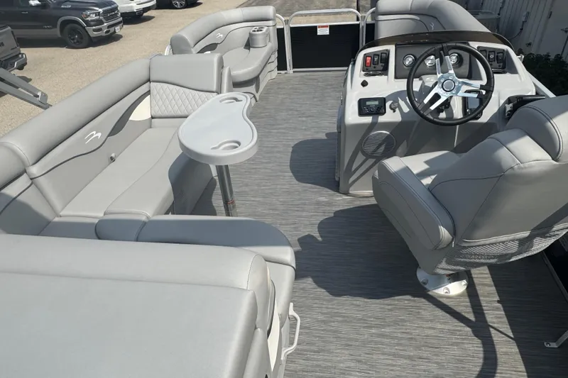 Slide: The Image of 2023 Bennington 20 SL pontoon boat interior with gray seating and steering console. - 22