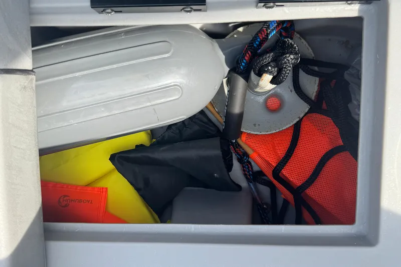 Slide: The Image of Storage compartment in 2023 Bennington 20 SL boat with safety gear and equipment. - 24