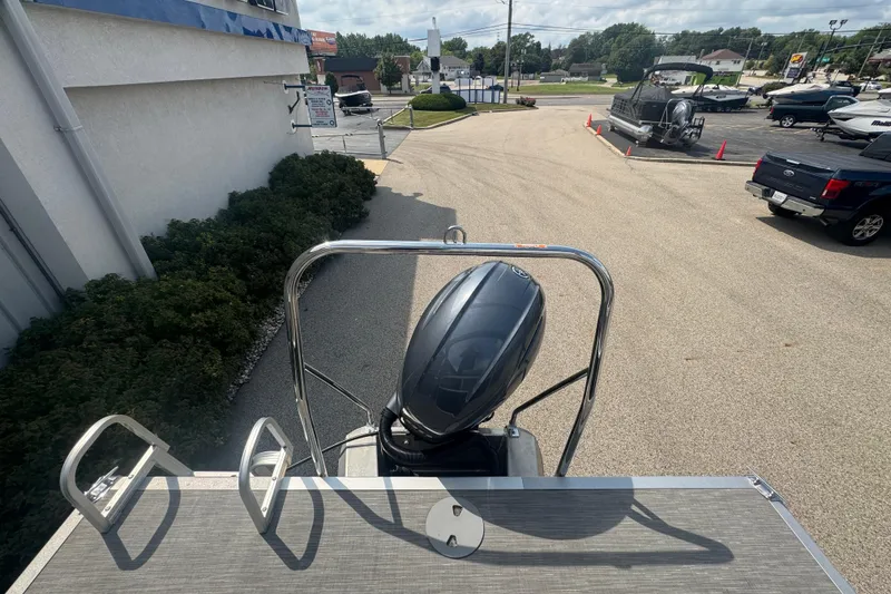 Slide: The Image of 2023 Bennington 20 SL pontoon boat with outboard motor in a dealership lot. - 28