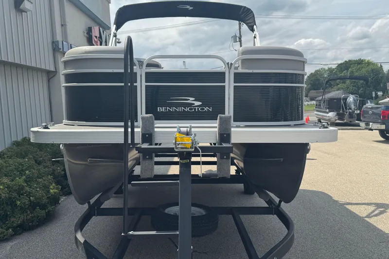 Slide: The Image of 2023 Bennington 20 SL pontoon boat on trailer, parked outdoors. - 4