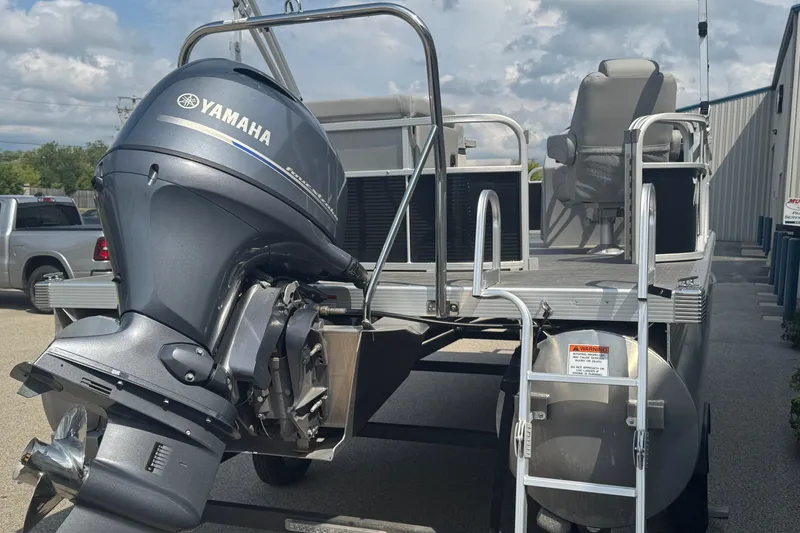 Slide: The Image of 2023 Bennington 20 SL pontoon boat with Yamaha outboard motor, parked outdoors. - 7