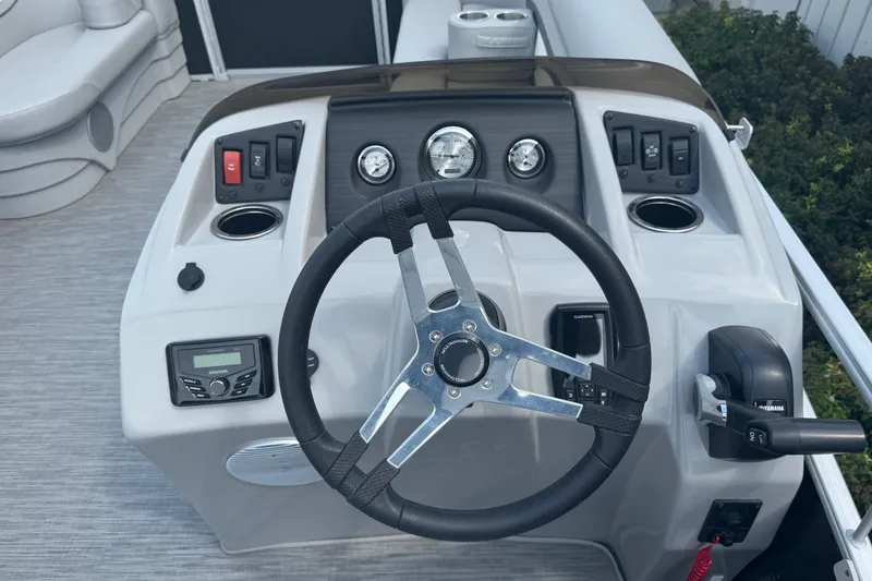 Slide: The Image of 2023 Bennington 20 SL boat dashboard with steering wheel and control panel. - 9