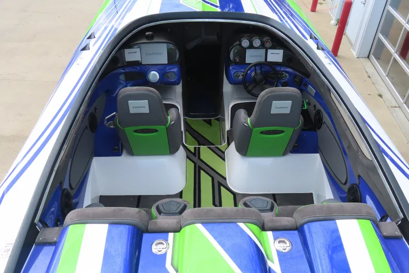 Slide: The Image of 2007 Outerlimits 44 GTX cockpit with vibrant blue and green interior design. - 14
