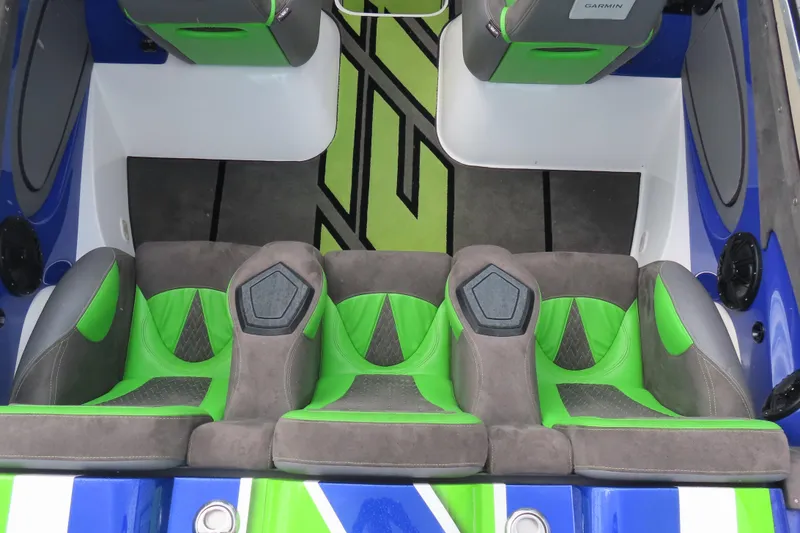 Slide: The Image of 2007 Outerlimits 44 GTX boat interior with green and gray seating, modern design. - 15