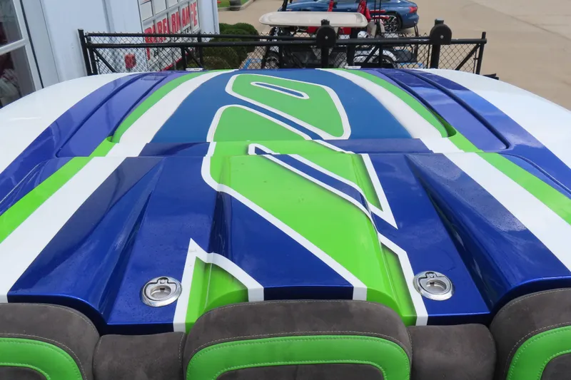 Slide: The Image of 2007 Outerlimits 44 GTX boat with vibrant blue and green design. - 20