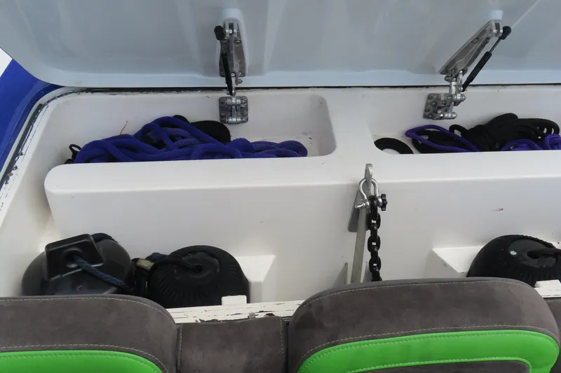Slide: The Image of Open storage compartment on 2007 Outerlimits 44 GTX boat, showing ropes and equipment. - 21