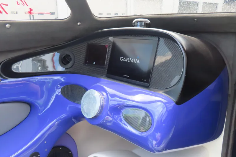 Slide: The Image of 2007 Outerlimits 44 GTX dashboard with Garmin navigation system, featuring sleek blue design. - 23