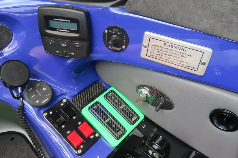 Slide: The Image of 2007 Outerlimits 44 GTX boat dashboard with marine intercom and warning label. - 26