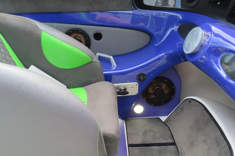 Slide: The Image of 2007 Outerlimits 44 GTX interior with vibrant green and blue accents. - 28
