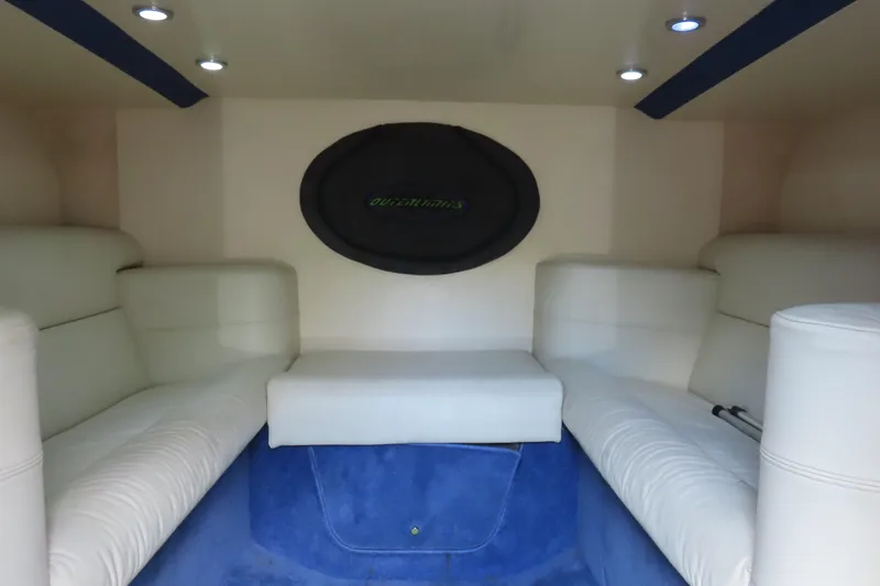 Slide: The Image of Interior of 2007 Outerlimits 44 GTX boat with white seating and blue accents. - 36