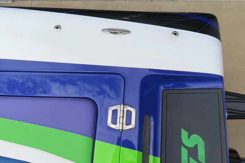 Slide: The Image of 2007 Outerlimits 44 GTX boat with blue, green, and white design details. - 39